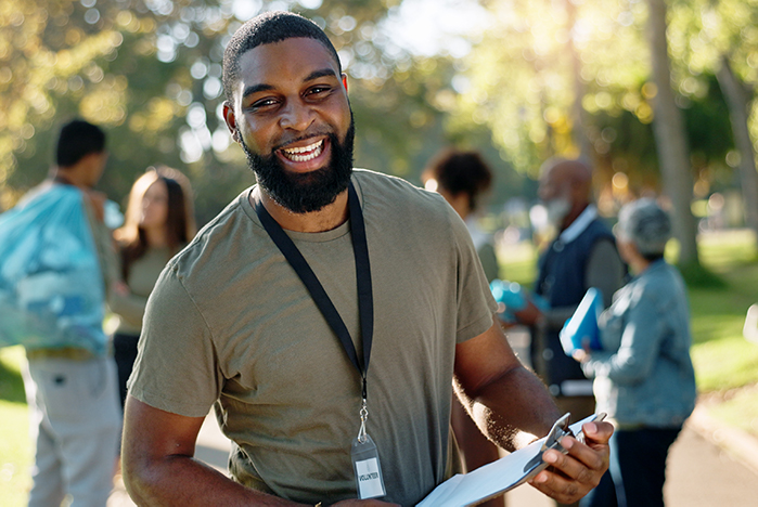 Smiling man with beard volunteering with charity